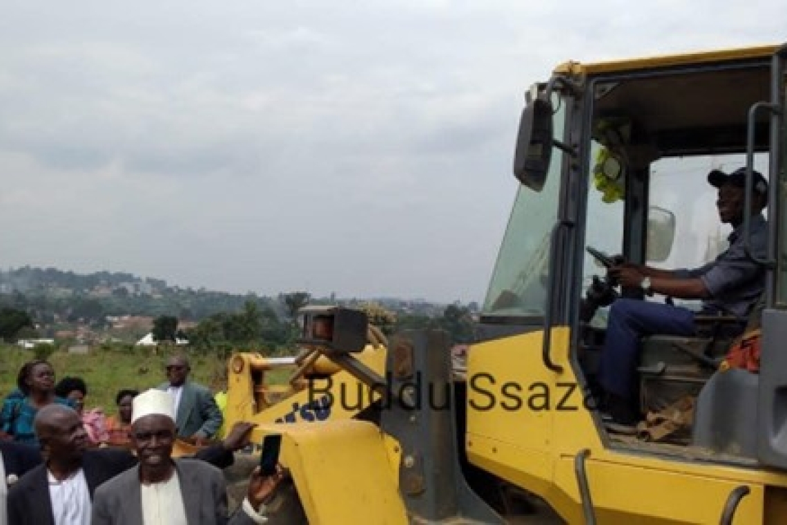 Buddu County Chief Pookino Jude Muleke operating the grader Image